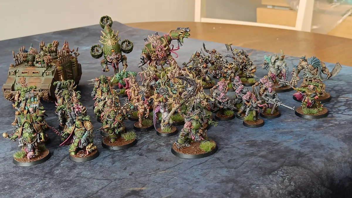 A painted Death Guard army on a gaming mat